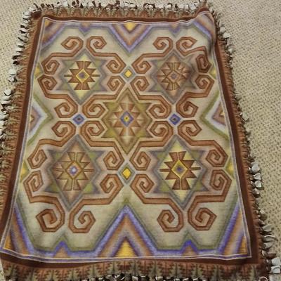 Two throw pillows and a handmade knot lap blanket