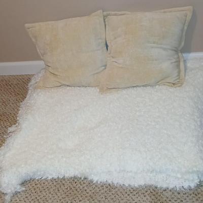 Two throw pillows and a Bella Lux Fine Linen light weight blanket