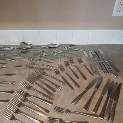 Lots of mismatched flatware - spoons - forks - knives and serving flatware