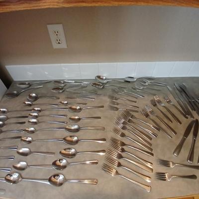Lots of mismatched flatware - spoons - forks - knives and serving flatware