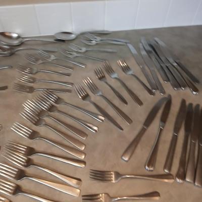 Lots of mismatched flatware - spoons - forks - knives and serving flatware