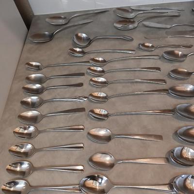 Lots of mismatched flatware - spoons - forks - knives and serving flatware