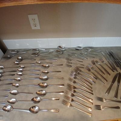 Lots of mismatched flatware - spoons - forks - knives and serving flatware