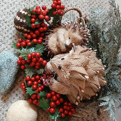 Christmas wreath with basket of holly, and pine with adorable porcupines