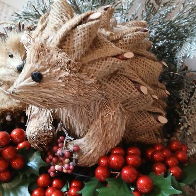 Christmas wreath with basket of holly, and pine with adorable porcupines