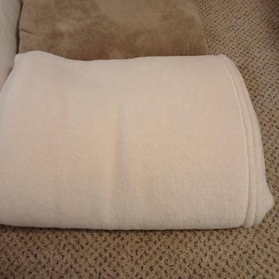 Two queen size blankets and a wedge pillow