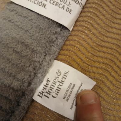 Grey and maroon towels with a better homes & garden memory foam bathmat