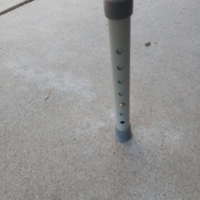 Mobility commode with an adjustable walking cane