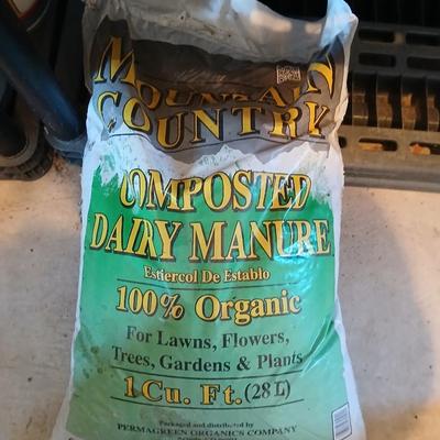 Bag of Dairy manure Organic compost and some bricks