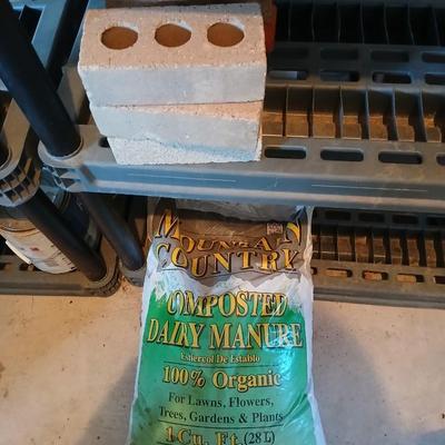 Bag of Dairy manure Organic compost and some bricks