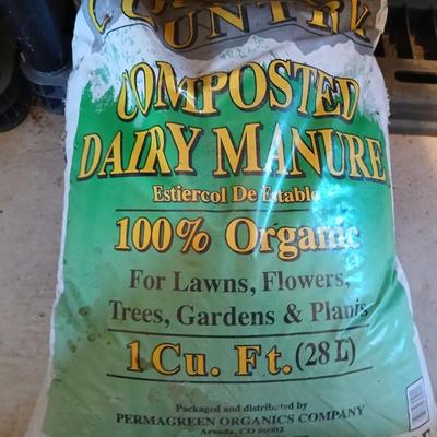 Bag of Dairy manure Organic compost and some bricks