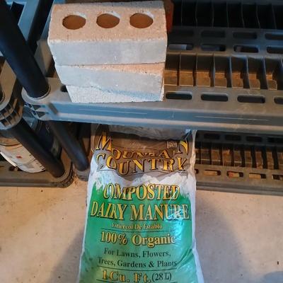 Bag of Dairy manure Organic compost and some bricks