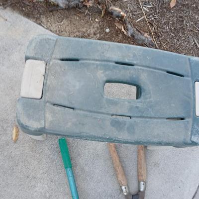 Two step plastic gardening bench with a pair of trimmers and a small pack shovel