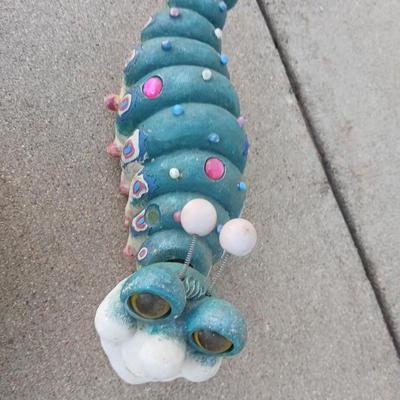 Handmade glass flower from plate and teacup and an adorable caterpillar that wants to frolic in your garden!