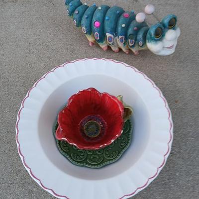 Handmade glass flower from plate and teacup and an adorable caterpillar that wants to frolic in your garden!