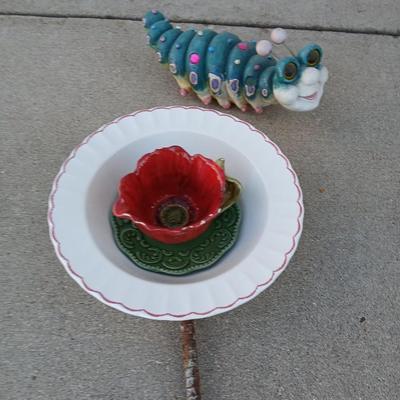 Handmade glass flower from plate and teacup and an adorable caterpillar that wants to frolic in your garden!