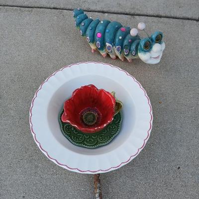 Handmade glass flower from plate and teacup and an adorable caterpillar that wants to frolic in your garden!