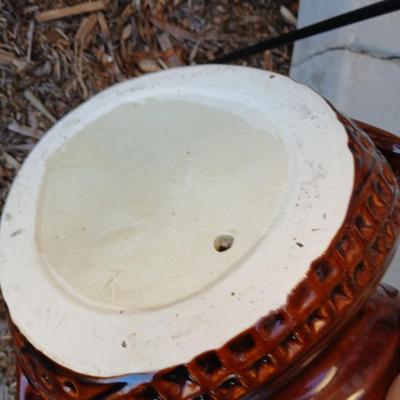 Pottery pot for plants, and a shepherd hook