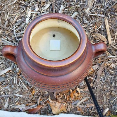 Pottery pot for plants, and a shepherd hook