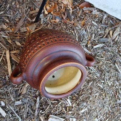 Pottery pot for plants, and a shepherd hook