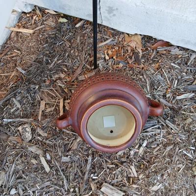 Pottery pot for plants, and a shepherd hook