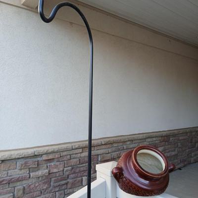 Pottery pot for plants, and a shepherd hook