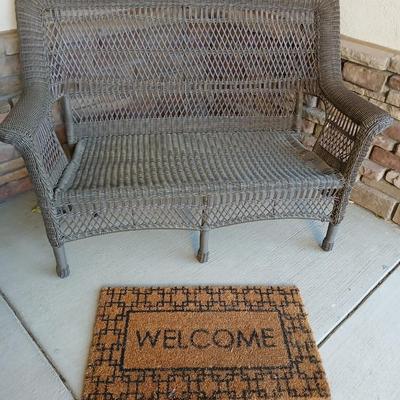 Plastic Wicker like patio bench with nice Welcome mat