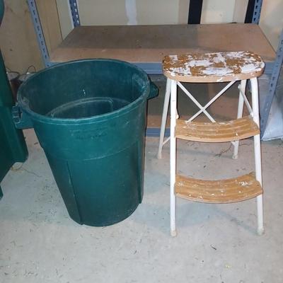 Footstool and a green trashcan with lid