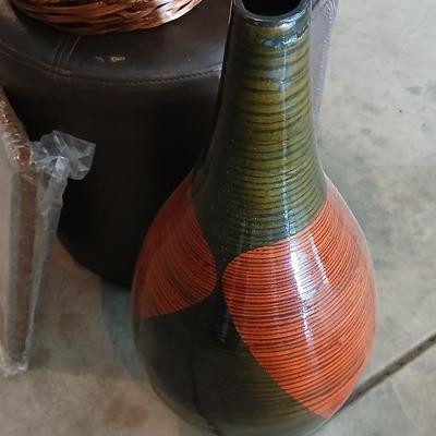 Footstool - wicker basket with balls and a tall vase