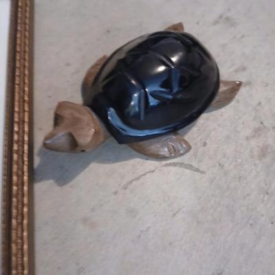 Three framed wall art and a small turtle figure
