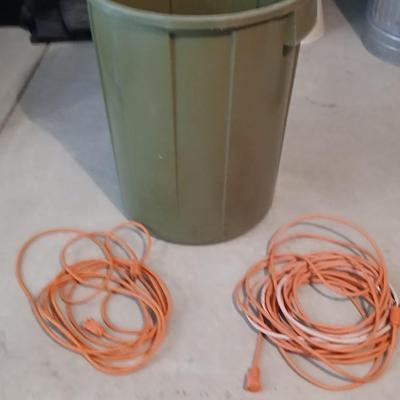Large green trash can with extension cords