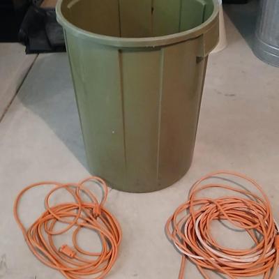 Large green trash can with extension cords
