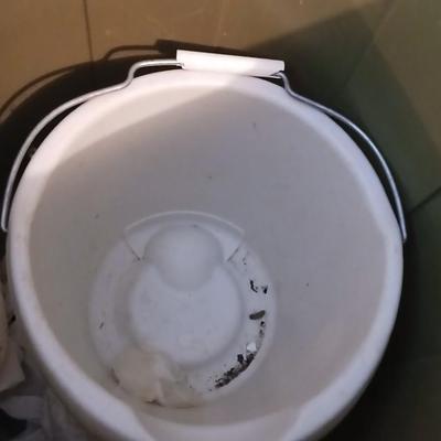 Large green trash can with extension cords