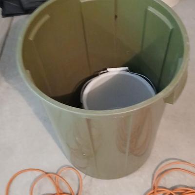Large green trash can with extension cords