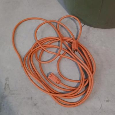 Large green trash can with extension cords