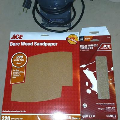 Black and decker electric sander with some sandpaper