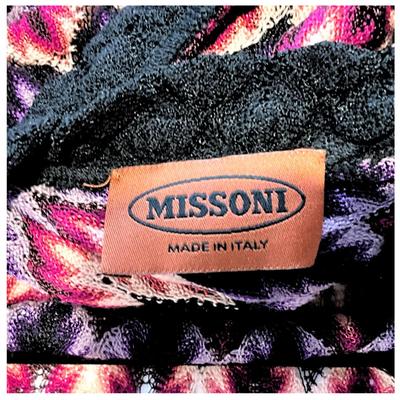 Sale Photo Thumbnail #387: Brand: Missoni
Size: 42
Description: Stunning Missoni multicolor knit dress featuring an eye-catching chevron pattern in shades of purple, pink, and black. Designed with a flattering wrap-around style and textured knit fabric for an effortlessly chic look