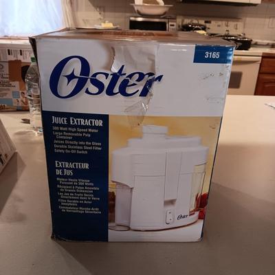 NEW OSTER JUICE EXTRACTOR