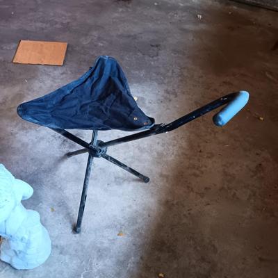 FOLDING UMBRELLA CHAIR AND A CONCRETE YARD ART