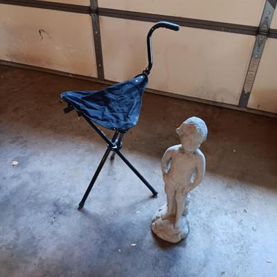 FOLDING UMBRELLA CHAIR AND A CONCRETE YARD ART
