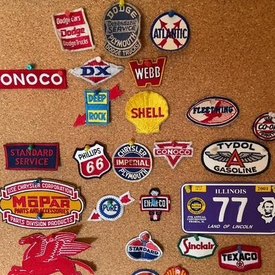 Cork board full of vintage auto patches