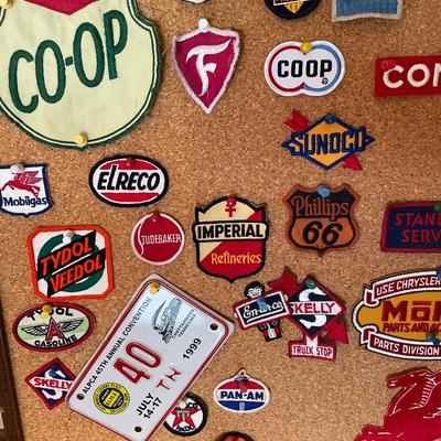 Cork board full of vintage auto patches