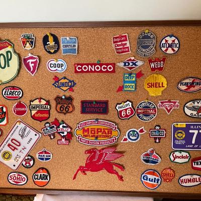 Cork board full of vintage auto patches