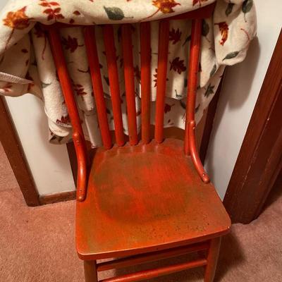 Vintage red chair with autumn theme blanket
