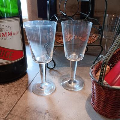 TALL EMPTY CHAMPAGNE BOTTLE, WINE RACK, BOTTLE HOLDER AND 4 STEMMED GLASSES