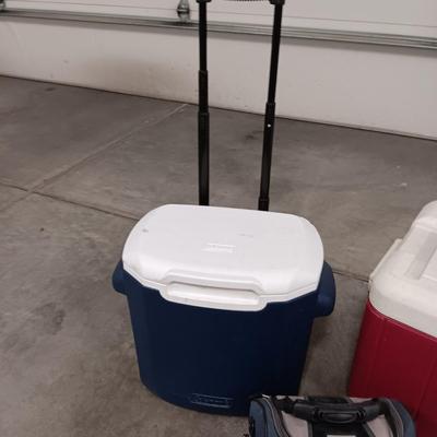 COLEMAN KWIK SERV COOLER AND ANOTHER ON WHEELS PLUS A LUNCH BAG AND UMBRELLA