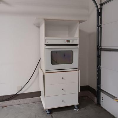 GE ELECTRIC OVEN IN A 3 DRAWER DROP LEAF CABINET ON CASTERS