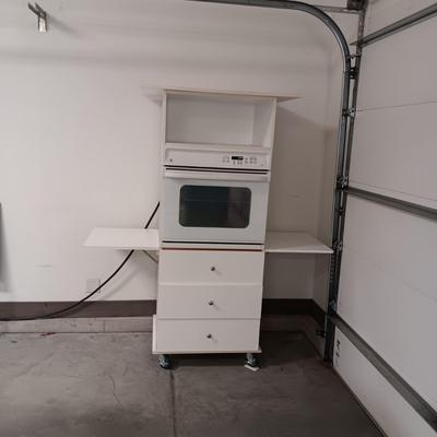 GE ELECTRIC OVEN IN A 3 DRAWER DROP LEAF CABINET ON CASTERS