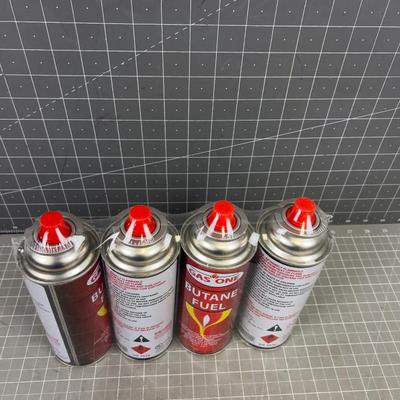 (4) NEW BUTANE CANS