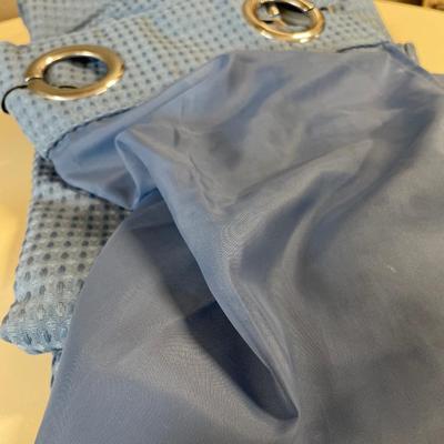 Blue fabric shower curtain and towels
